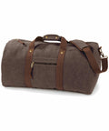Quadra's QD613 brown canvas duffel bag features leather straps, a front zippered pocket, and an adjustable shoulder strap.
