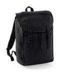 A Quadra QD615 black canvas backpack featuring a flap top, two buckle closures, and adjustable shoulder straps.