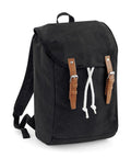 The QD615 by Quadra is a black canvas backpack featuring a flap closure, brown leather straps, and white drawstrings.