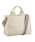 The Bags product is a structured beige canvas tote featuring two short handles, a long adjustable shoulder strap, and a taupe stripe. Its design is minimalist with minimal visible details.