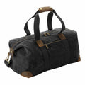 The Quadra QD650 is a black canvas duffel bag featuring brown leather accents and two zippered compartments.
