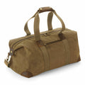 The Quadra QD650 is a brown canvas duffle bag featuring a zippered top, a front pocket, and sturdy handles.