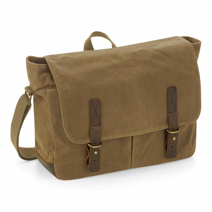 Quadra's QD653 features a brown canvas design with a top flap, two leather buckle straps, and an adjustable shoulder strap.