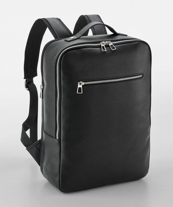 A Quadra QD774 black leather backpack with adjustable shoulder straps, a top handle, a front zippered pocket, and a main compartment with a zipper closure.