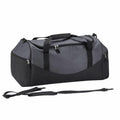 The QS070 by Quadra is a black and gray duffel bag featuring multiple zippered compartments, convenient carrying handles, and a detachable shoulder strap, set against a white background.