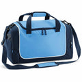 The QS077 by Quadra is a blue and black sports duffel bag featuring a front zipper pocket, two handles, and an adjustable shoulder strap. It is stylishly designed with contrasting white piping around the front pocket.