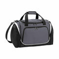 The QS277 by Quadra is a spacious duffel bag featuring a gray front and black sides. It comes equipped with a top handle, side handles, and an adjustable shoulder strap for versatile carrying options. The bag includes multiple zippered compartments for enhanced storage and boasts contrasting white piping accents.