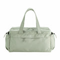 A light green QS300 duffel bag by Quadra, featuring side pockets and double handles.