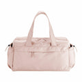 A light pink QS300 duffel bag by Quadra, equipped with short handles, a zippered top, and side pockets.
