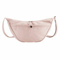 A Quadra QS309, a beige shoulder bag designed in a crescent shape, featuring a zipper closure and adjustable straps.