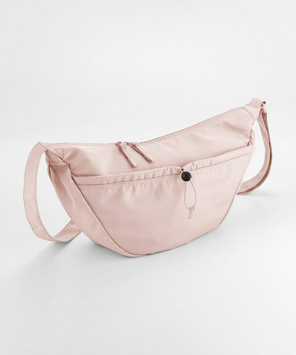 A light pink, crescent-shaped crossbody bag with a front zip pocket and a long adjustable strap, the QS309 by Quadra.
