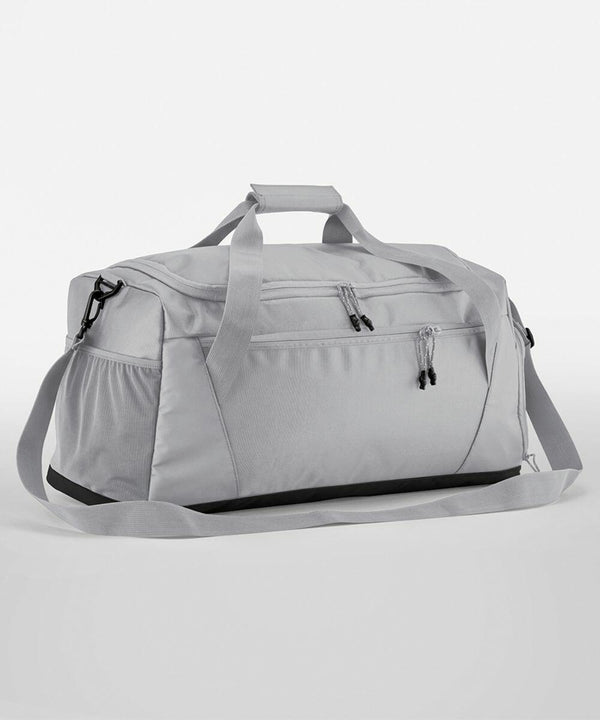 Gray Quadra QS477 duffel bag with multiple zippered compartments, short handles, and an adjustable shoulder strap, set against a plain white background.