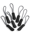 Six QX505 zipper pulls by Quadra, featuring black bodies with gray loops, are arranged on a white background.