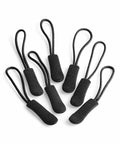 Seven Quadra QX505 black zipper pull replacements with looped cord handles are arranged against a white background.