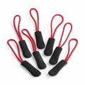 Seven QX505 zipper pulls by Quadra in a red and black color scheme are arranged on a white background, showcasing their looped design and textured handles.