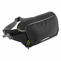 A three-quarter angle view of the Quadra QX515 sling bag, featuring a black and gray design with lime green zippers and an adjustable strap.