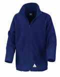 The Result Core R114J, a blue zip-up fleece jacket featuring a high collar and long sleeves, is showcased against a white background. Its design is simple, highlighted by a small triangular logo on the lower front.