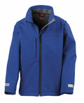 The Result R121J is a blue zip-up jacket featuring a high collar and two front pockets. It includes a black zipper that runs vertically down the center and has gray lining at the collar. The sleeves are designed with reflective strips, and the material appears to be softshell.