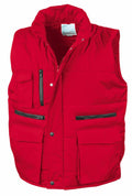 Introducing the Result Workguard R127A: a vibrant red quilted vest designed with functionality in mind. It comes equipped with a zippered front closure, two zippered chest pockets, two buttoned flap pockets, and a high collar for added protection.