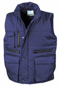 Introducing the Result Workguard R127A: a blue padded vest featuring a high collar and multiple pockets, including two zippered chest pockets and large flap waist pockets. This sleeveless vest is designed with a front zipper closure secured by snap buttons for added convenience.