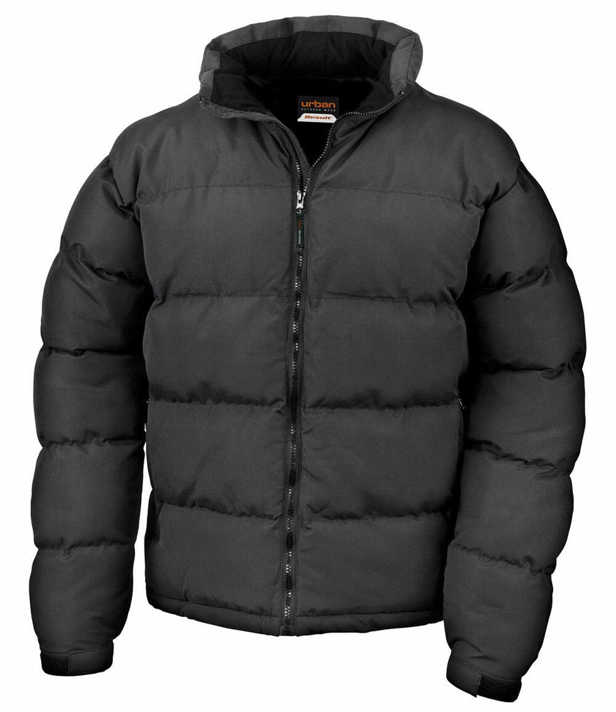 The Result Urban Outdoor R181M is a black puffer jacket featuring a front zipper and a hood.