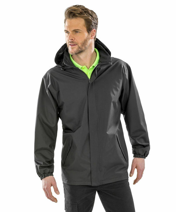 A man wearing a black hooded jacket (Result R206X) over a bright green shirt looks to the side.