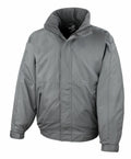 The product displayed against a plain white background is the R221M jacket from Result Core, featuring a gray color, long sleeves, a high collar, and two side pockets.