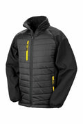 The R237X from Result Genuine Recycled is a black padded jacket featuring distinctive yellow zipper accents on the chest and pockets. It boasts a high collar and elastic cuffs, combining a quilted front pattern with smooth sleeves and sides.