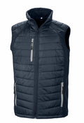 The Result Genuine Recycled R238X is a dark gray padded vest designed with a high collar and zippered front. It includes two zippered pockets on each side and has quilted stitching for extra texture. This sleeveless vest is perfect for layering in colder weather.