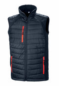 The R238X by Result Genuine Recycled is a sleeveless black quilted vest designed with a high collar and a full-length front zipper. It features two red zippered pockets at the waist and one red zippered pocket on the chest.