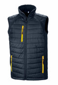 Introducing the R238X by Result Genuine Recycled: A stylish sleeveless black quilted vest designed with a high collar and front zipper closure. It features three functional yellow zippered pockets—two at the bottom and one on the chest—to enhance both style and practicality.