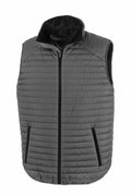 The Result Genuine Recycled R239X puffer vest, in a gray shade, is showcased against a white background. This sleeveless vest includes a front zipper and two zippered side pockets. It has a raised collar and features a quilted design for enhanced texture and warmth.