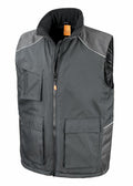 The Result Work-Guard R306X is a dark gray vest featuring multiple pockets, a zipper front, and contrasting shoulder panels.