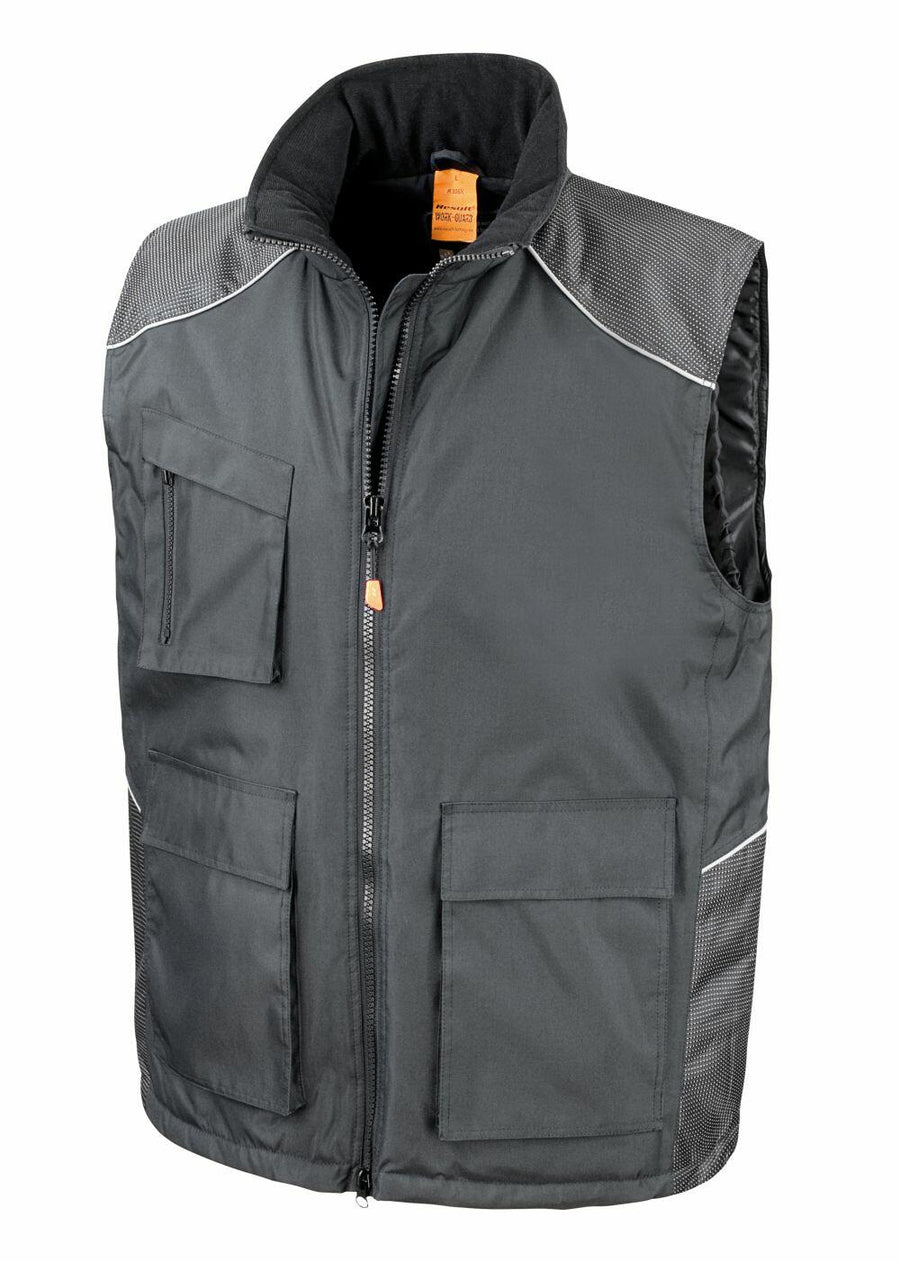The Result Work-Guard R306X is a dark gray vest featuring multiple pockets, a zipper front, and contrasting shoulder panels.