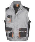 The R317X by Result Work-Guard is a gray and black utility vest featuring multiple pockets and orange accents.