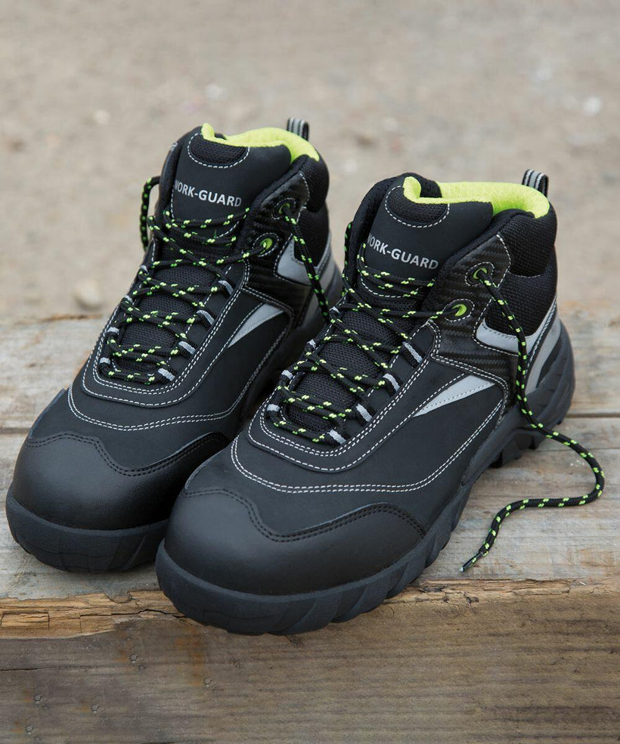 A pair of black work boots with green and black laces labeled "Result R339X" on a wooden surface.