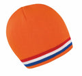 The R368X by Result Winter Essentials is an orange knit beanie featuring a striped band near the edge with white, blue, and red horizontal stripes.