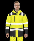 A man wearing a bright yellow and black high-visibility jacket with reflective stripes, the Result R475X, stands in front of a black background.