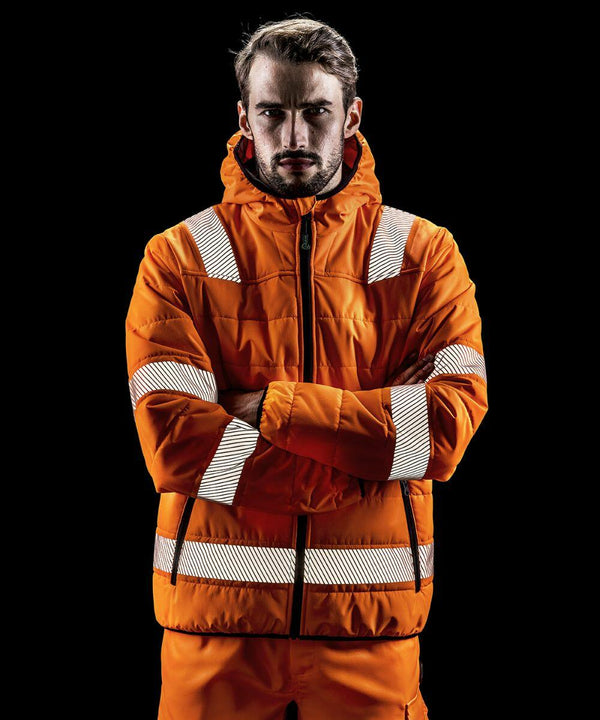 Person wearing an orange Result R500X reflective jacket with hood and matching pants stands with arms crossed against a black background.