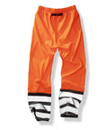 Bright orange waterproof trousers with an elastic waistband and black-and-white striped cuffs, shown on a white background.