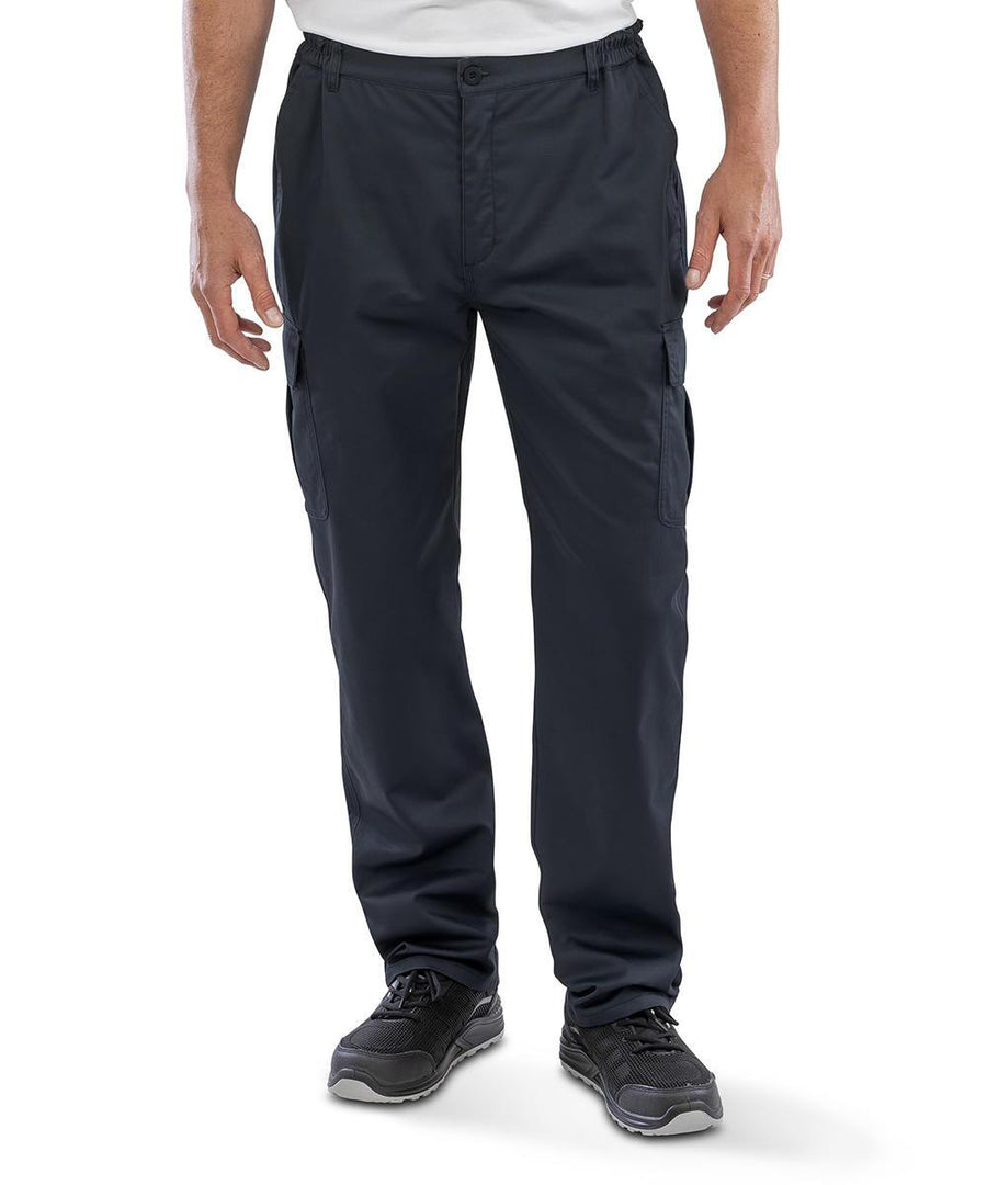 A person is shown from the waist down, standing against a plain white background, wearing Result Recycled Recycled work-guard utility trousers with a white shirt and black trainers.