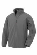 The Result Genuine Recycled R901M softshell jacket, shown on a white background, is gray and includes a high collar, full zip closure, and two side zippered pockets. It boasts a smooth finish and looks warm and functional.