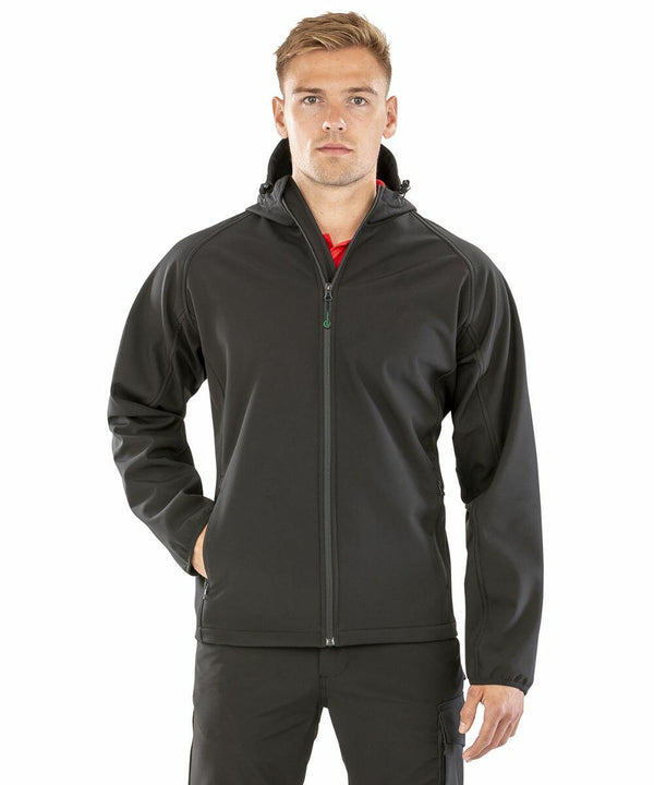 A man stands facing forward wearing a Result Genuine Recycled R911M zip-up jacket with his left hand in his pocket.