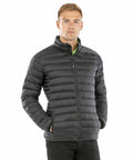 A man wearing a black Result Genuine Recycled R912X puffer jacket and black pants stands against a white background.