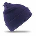 The Result Winter Essentials RC029, a deep purple knit beanie with a folded brim, is displayed against a white background, casting a small shadow beneath.