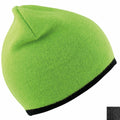 A vibrant green RC046 knit beanie by Result Winter Essentials is showcased against a white background, featuring a black trim around the edge. The hat looks soft and cozy, making it ideal for cold weather. A small inset highlights the texture of the fabric up close.