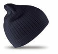 The Result Winter Essentials RC074 beanie hat, featuring a black ribbed knit design, is displayed against a white background.