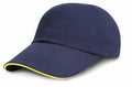 The RC24P, a product from Result Headwear, is a navy blue baseball cap featuring a short, curved brim with a thin yellow stripe lining its edge.