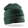 A green RC27X knit beanie from Result Winter Essentials, featuring a blank rectangular patch on the front.