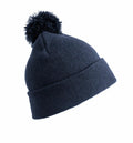 The RC28X navy blue knitted beanie by Result Winter Essentials features a folded brim and a large pom-pom on top, displayed against a plain white background.